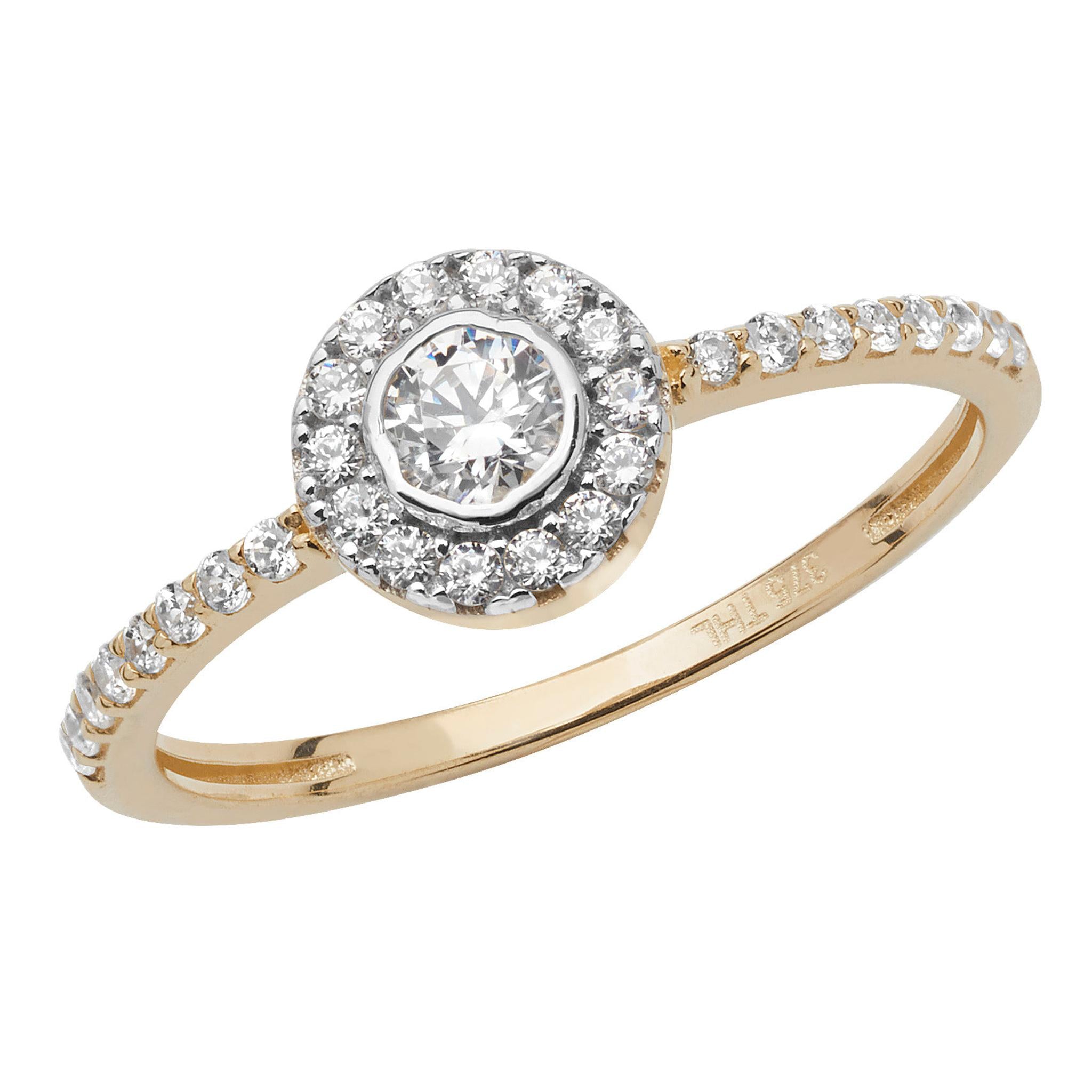 9ct gold ladies ring featuring a round central cubic zirconia, surrounded by a halo of smaller stones with additional cubic zirconias set along the shoulders.