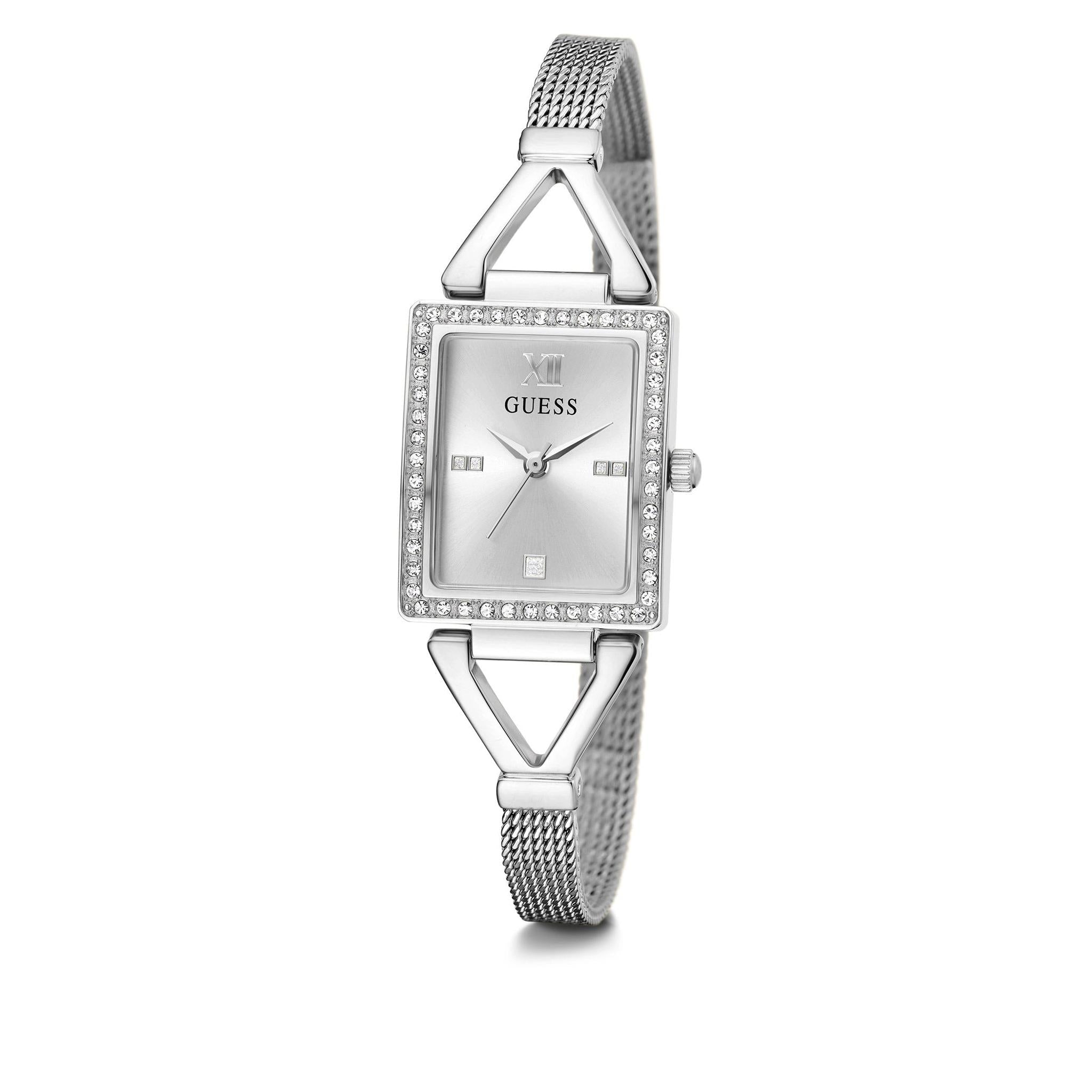 The Guess Ladies GW0400L1 Grace Silver Tone Watch features a rectangular case, mesh band, crystal-set bezel, minimalist silver dial, and geometric V-shaped lugs, shown against a white background.