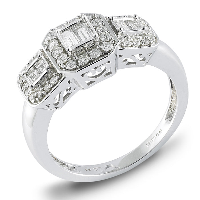 The 9ct White Gold Baguette and Brilliant Cut Diamond Trilogy Ring 0.50ct showcases three rectangular diamond clusters with round diamonds, set in white gold with decorative cut-out band details.