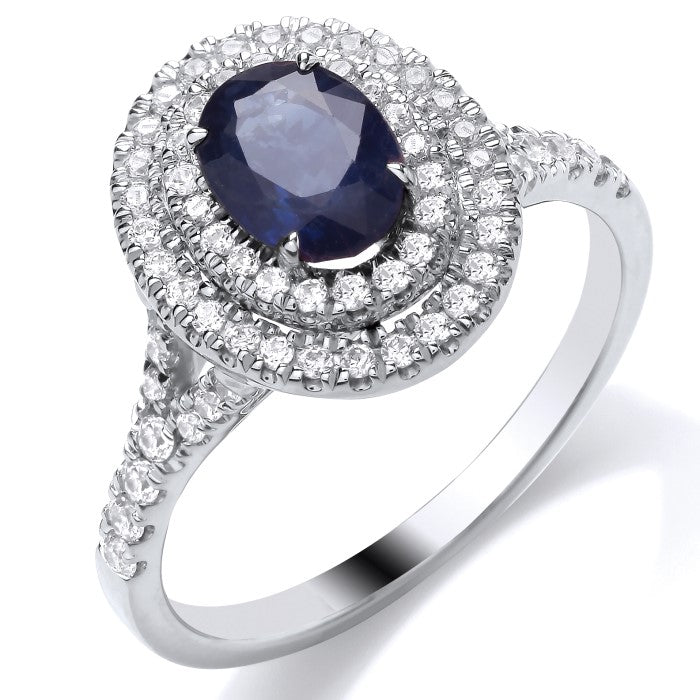 The 9ct White Gold Diamond and Sapphire Oval Cluster 0.40ct ring showcases an oval blue sapphire at the center, surrounded by sparkling diamonds and band accents—making it an elegant engagement ring choice.