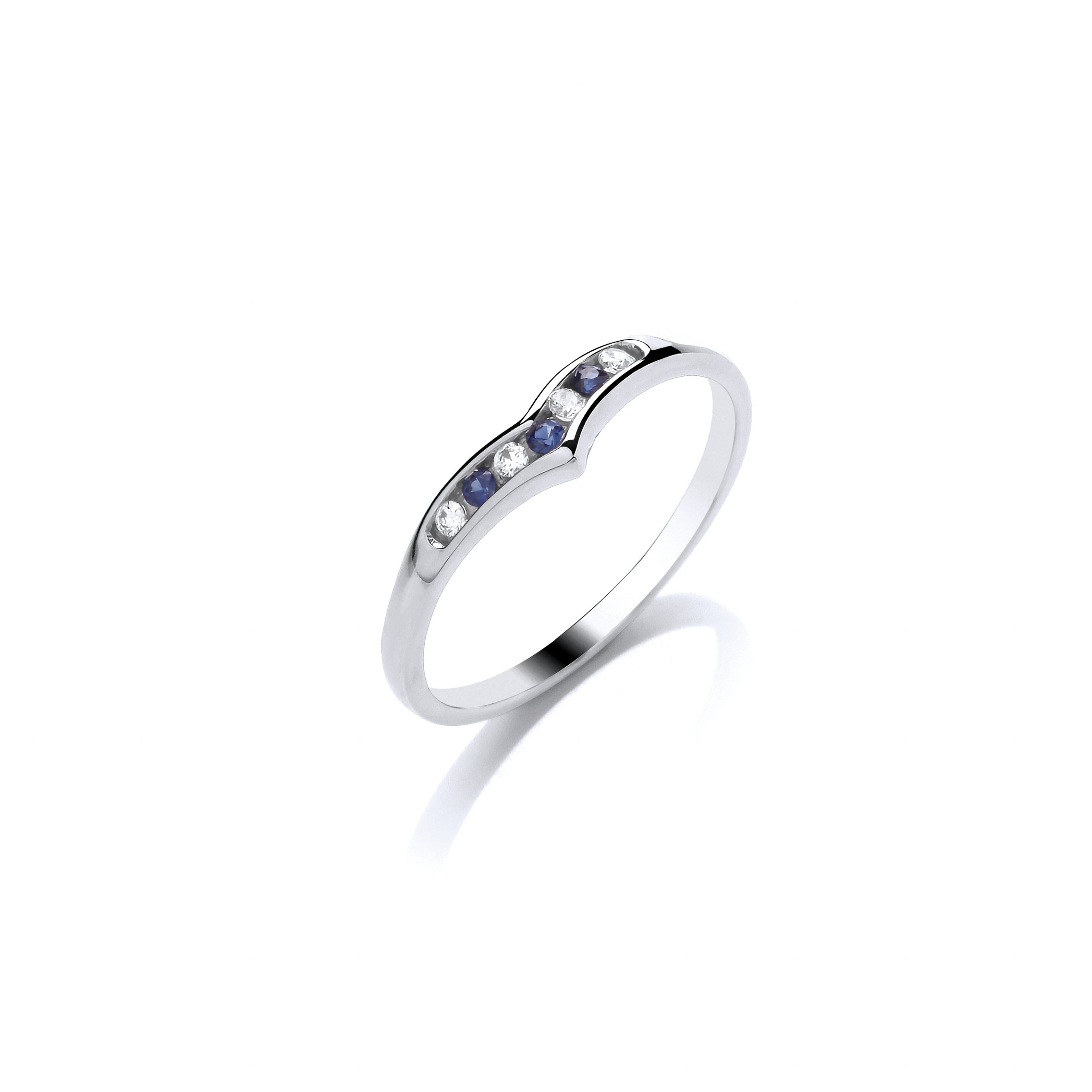 The 9ct White Gold Diamond and Sapphire Wishbone Ring .06ct features a silver curve with alternating blue sapphires and diamonds set in a stylish wishbone design, displayed on a white background.