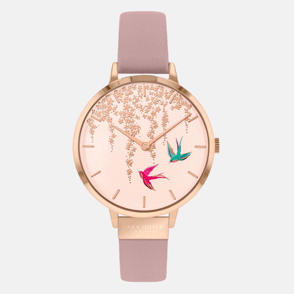 The SARA Miller Swallow Rose Gold Pink SA2060 features a rose gold-plated case, pale pink leather strap, floral patterns, and two colorful birds on the watch face for an elegant look.
