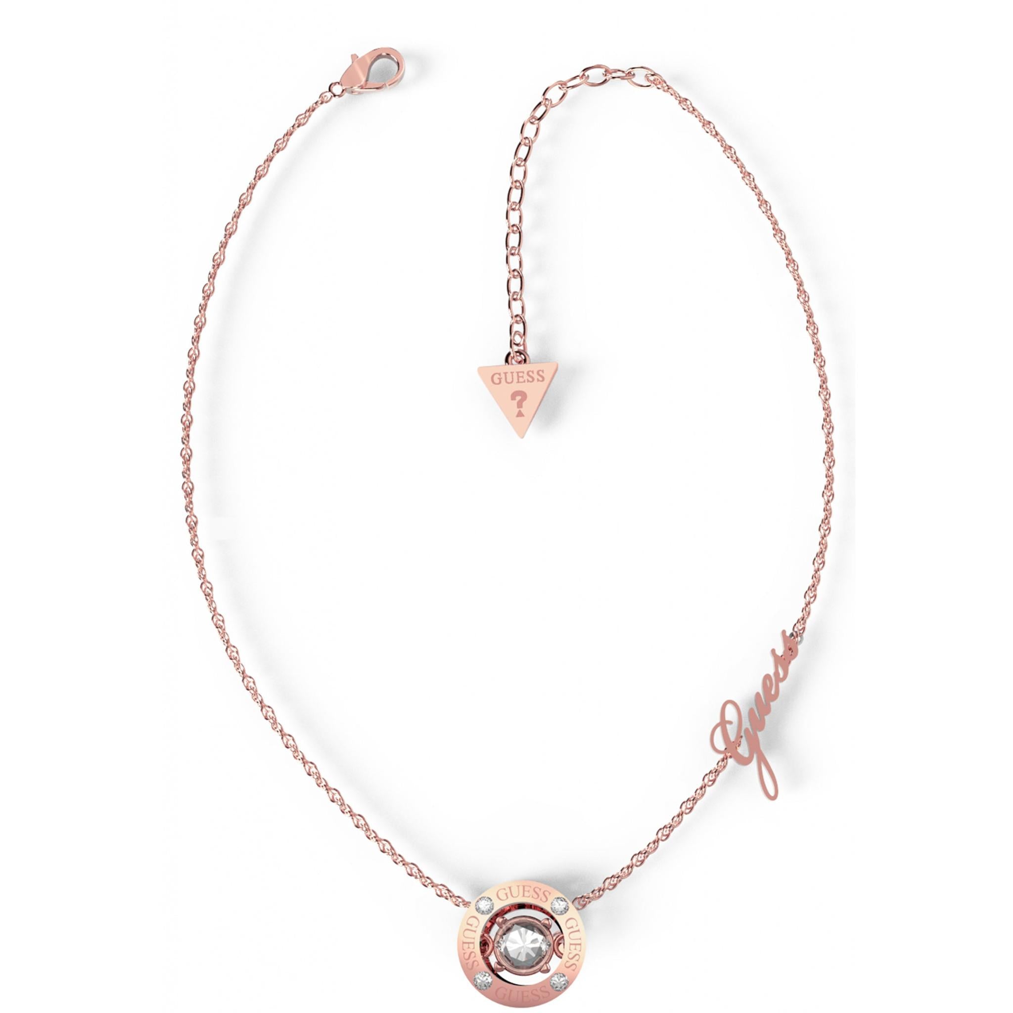Enhance your look with the Guess Jewellery Ladies Solitaire Rose Gold Tone Crystal Necklace UBN01459RG, featuring a sparkling crystal pendant, "Guess" branding, and a signature triangular tag on its adjustable clasp.