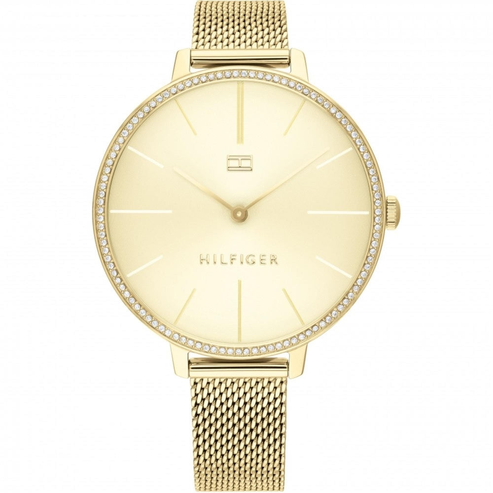 The Tommy Hilfiger 1782114 Kelly Ladies Gold Tone Mesh Bracelet Watch features a minimalist dial, small logo, rhinestones on the bezel, and quartz movement for timeless elegance.