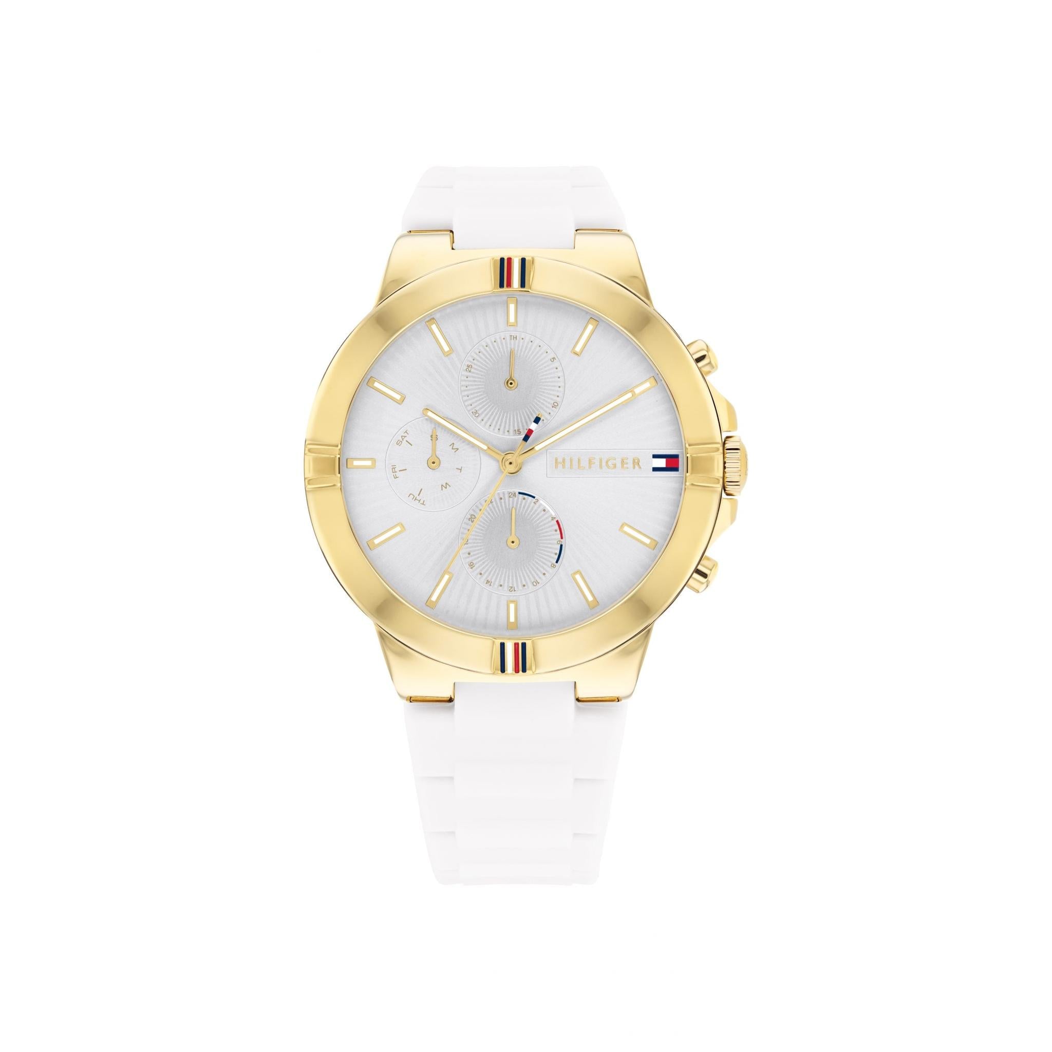 The TOMMY HILFIGER TALIA 1782333 is a ladies' watch with a white silicone strap, gold-tone stainless steel case, round face, three subdials, and the Tommy Hilfiger logo on the dial.