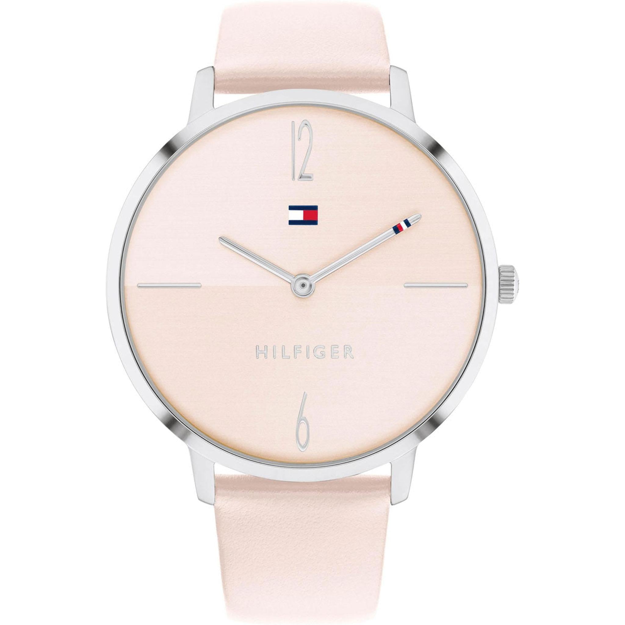 The TOMMY HILFIGER LIZA 1782378 is a minimalist ladies' watch with a pale pink leather strap, silver case, simple hour markers at 12 and 6, and the classic logo below the 12.