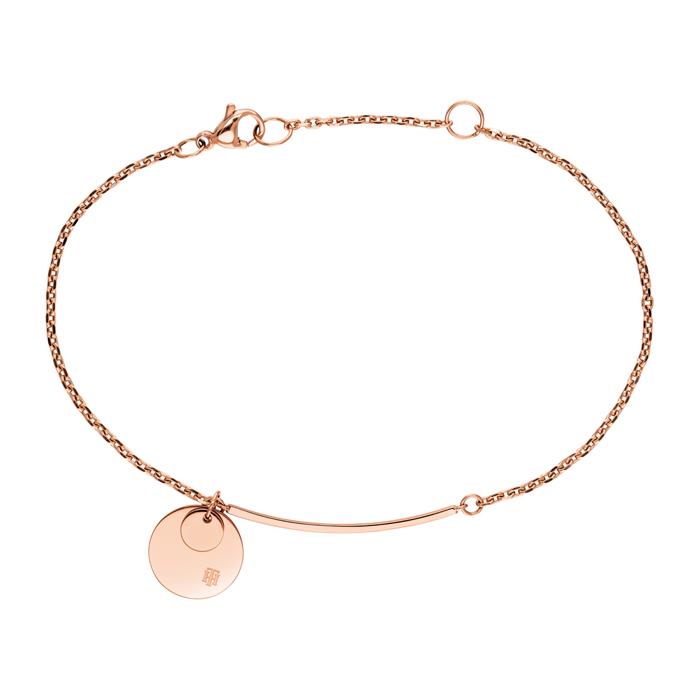 The TOMMY HILFIGER Ladies Engraveable Stainless Steel Disc Bracelet 2780261 features a rose gold tone, round disc charm, curved bar, and lobster clasp for a delicate and stylish look.