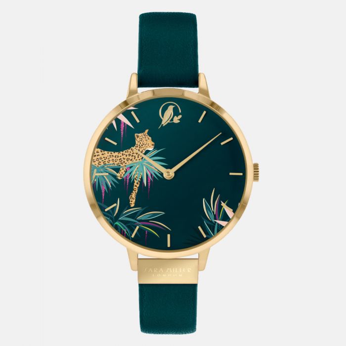 The Sara Miller Forest Green Leopard SA2084 is an elegant gold-plated wristwatch with a dark green face, leopard and tropical foliage design, gold hour markers, and a genuine green leather strap.