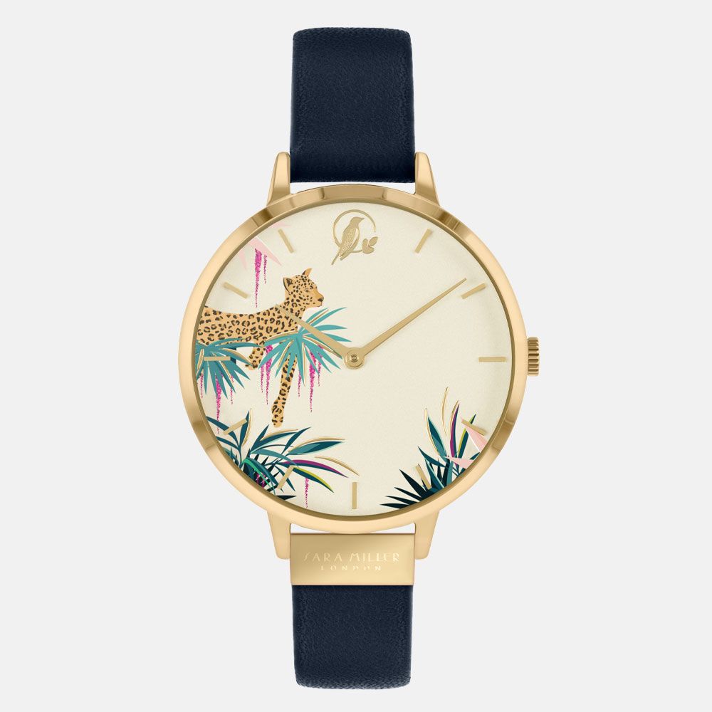 The Sara Miller Leopard Navy SA2086 features a gold-plated case, black leather strap, and a watch face adorned with a leopard amidst vibrant tropical foliage.