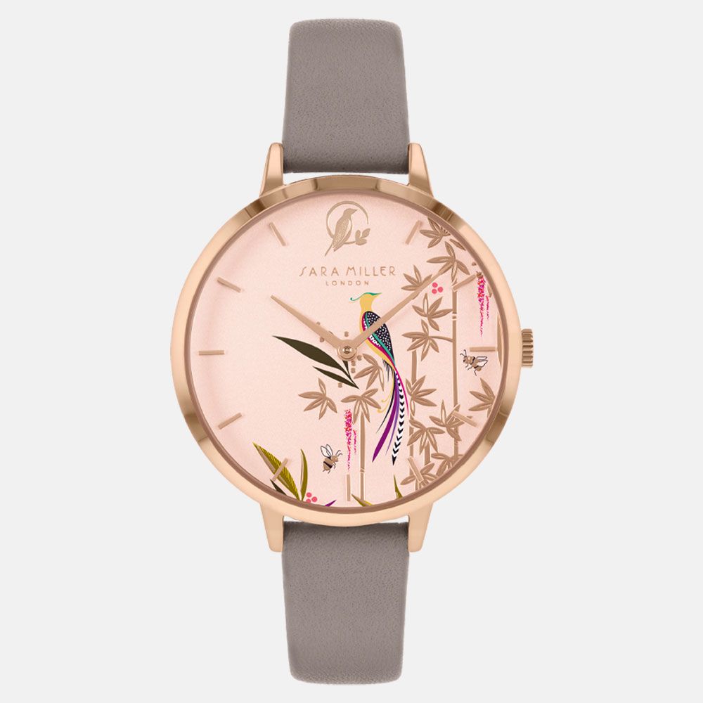 The Sara Miller Tropical Bird Gray SA2094 is a rose gold watch with a taupe leather strap and pink dial, featuring a bird and bamboo design with gold accents.