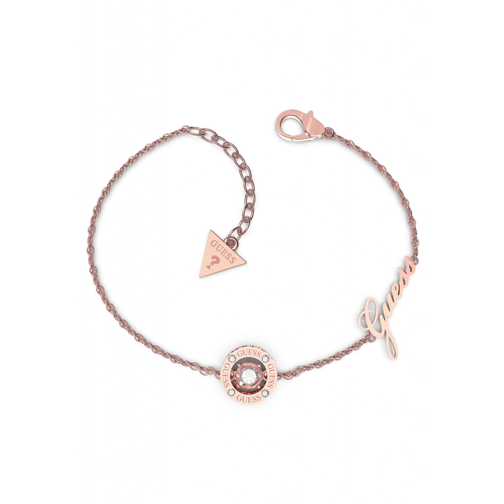 The GUESS JEWELLERY Ladies Rose Gold Tone GJ Solitaire Crystal Bangle UBB01462RGL features a solitaire crystal charm, triangle tag, "Guess" script accent, adjustable chain, and lobster clasp.