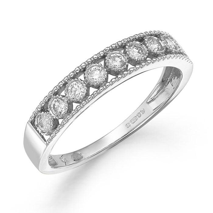 The 9ct White Gold Nine Stone Diamond Half Eternity Ring 0.25CT showcases a row of round-cut diamonds in elegant milgrain detailing along the band.