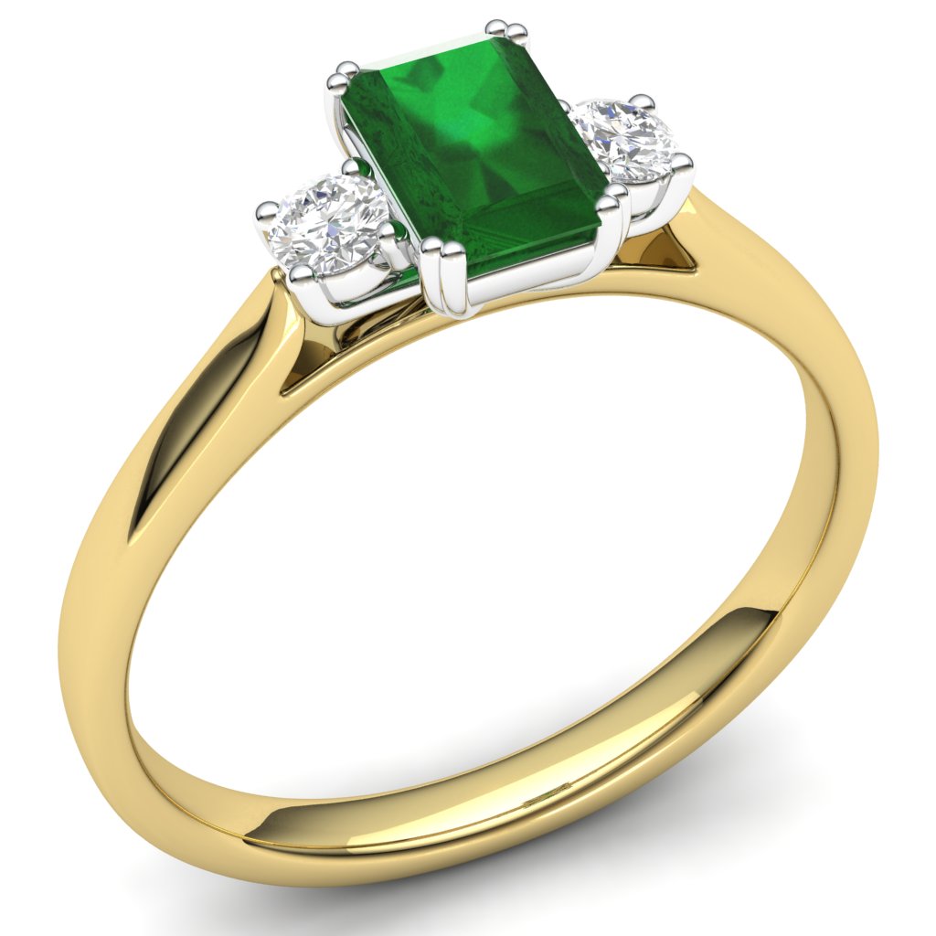The 9ct Yellow Gold 3 Stone Emerald And Diamond Ring showcases a central baguette cut emerald set in yellow gold, flanked by two sparkling round diamonds—a timeless and elegant piece.