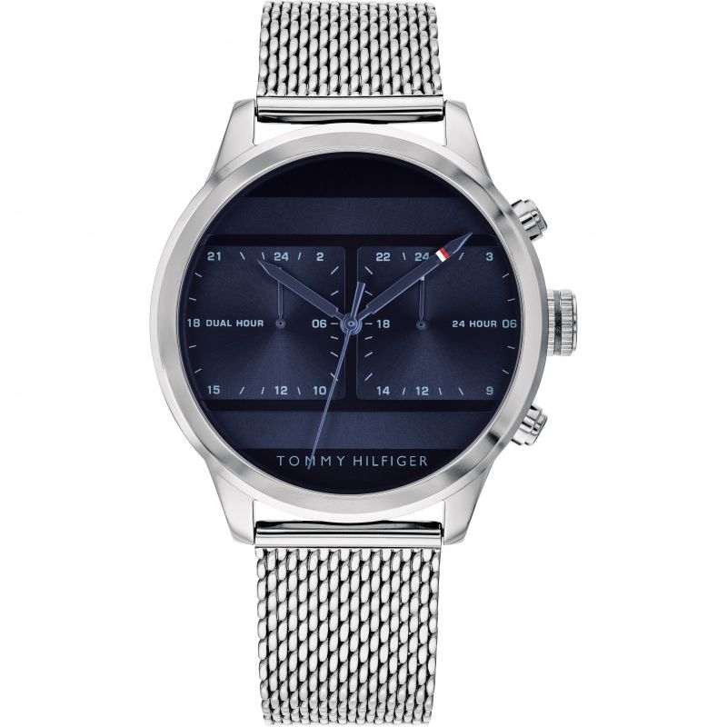 The Tommy Hilfiger 1791596 Icon Watch features a silver mesh band, dark blue face, and dual hour and 24-hour subdials.