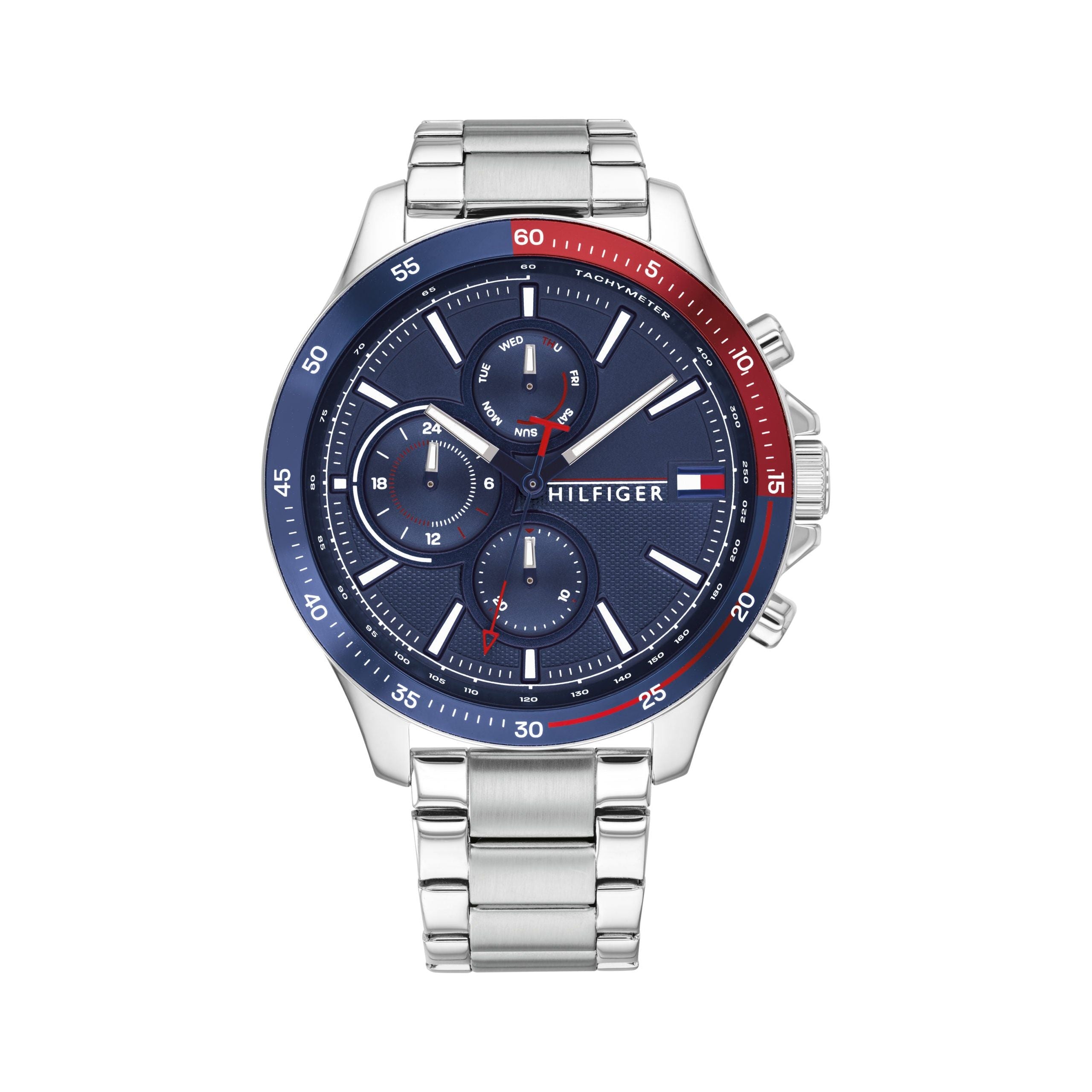 The TOMMY HILFIGER 1791718 Men's Bank watch features a silver stainless steel band, blue and red bezel, blue dial with three subdials, and "Hilfiger" branding on the face.