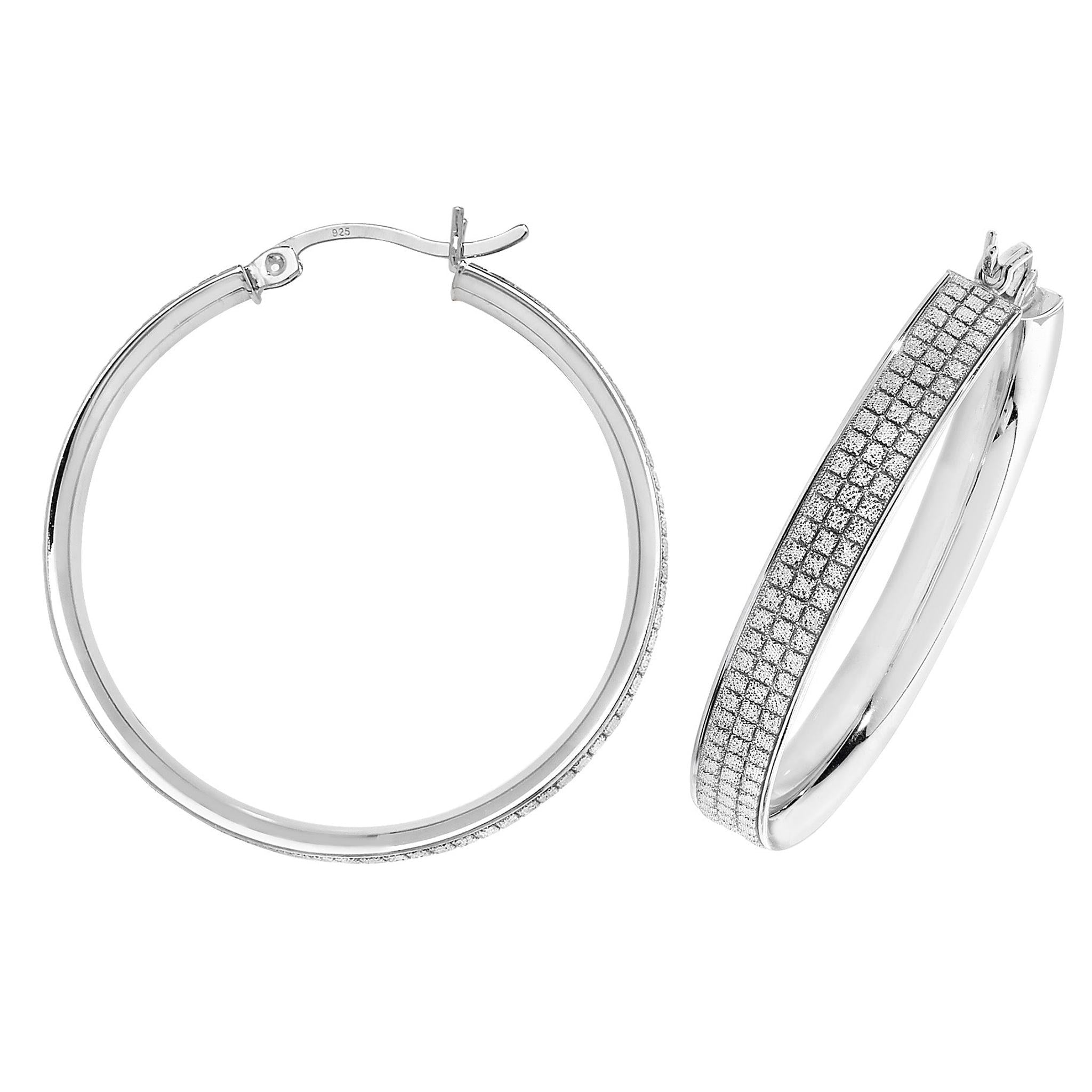 These Sterling Silver Ladies 30mm Glitter Hoop Earrings feature one plain hoop and one with rows of sparkling clear stones, adding elegance and shimmer to any outfit.