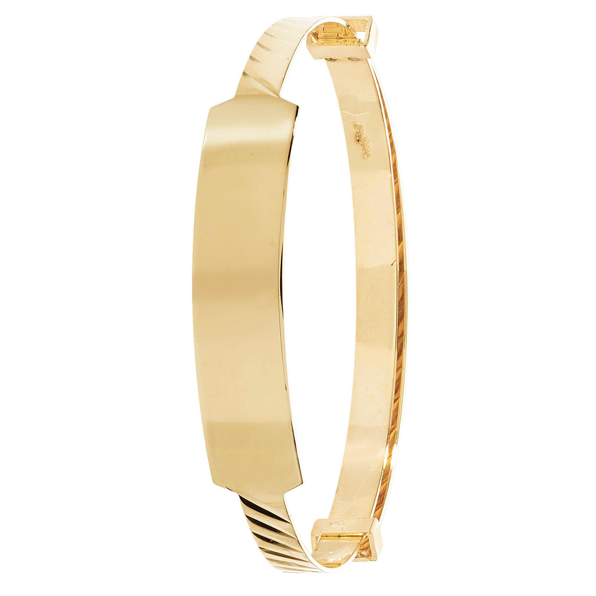 The 9CT GOLD DIAMOND CUT BABY EXPANDER ID is a gold engravable bracelet with a smooth, rectangular nameplate, hinged clasp, and subtle diamond-cut detailing on the edges.