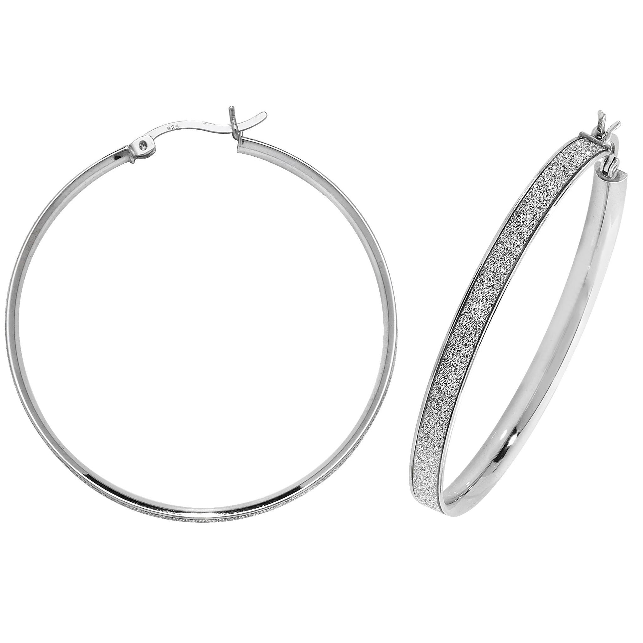The STERLING SILVER LADIES 40MM MOONDUST HOOP EARRINGS feature secure clasps and a polished finish, blending classic hoop style with elegant appeal; each earring measures 40mm wide.