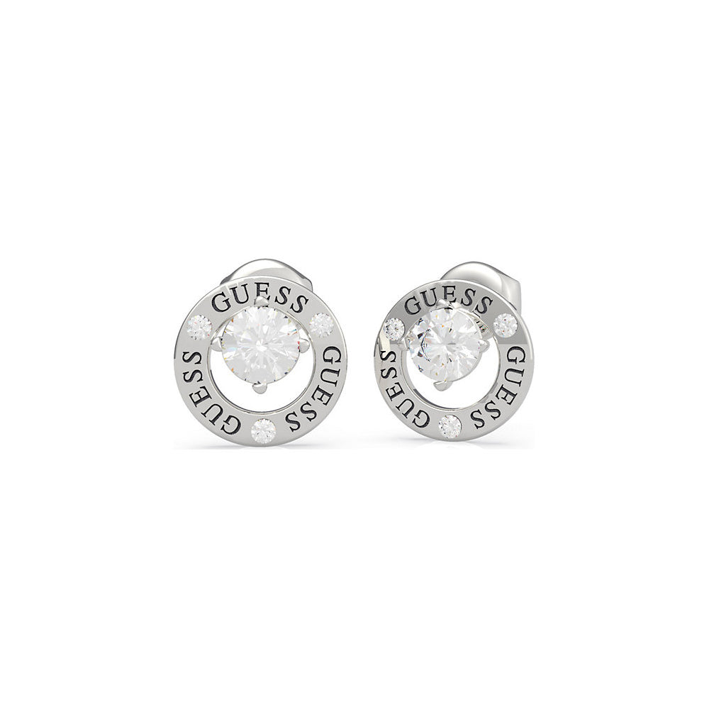 The Guess Jewellery All Around You Silver Tone Crystal Set Circle Earrings (UBE20134) feature a circular design with clear central stones, "GUESS" engraved on the border, and small crystal accents.