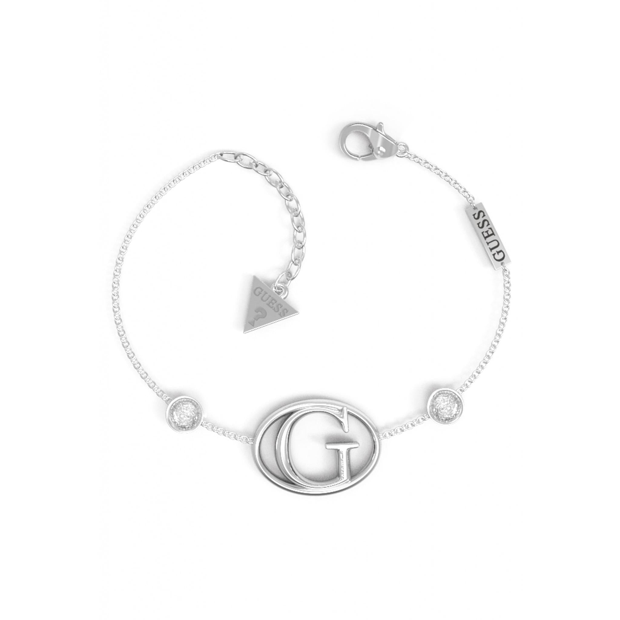 Elevate your style with the Guess Jewellery Ladies Silver Tone Iconic G Crystal Rhodium Plated Bracelet UBB01047RHL, featuring a bold "G" charm, sparkling crystals, lobster clasp, and signature branded tags for that iconic Guess look.