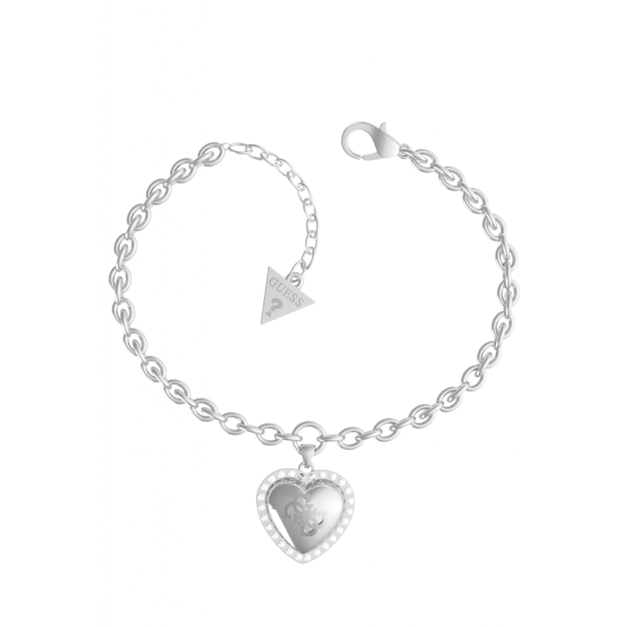 The GUESS JEWELLERY SILVER TONE That's Amore Heart Bracelet UBB01077RHL features a silver tone heart charm and a small triangle tag near the clasp, reflecting Guess's signature style.