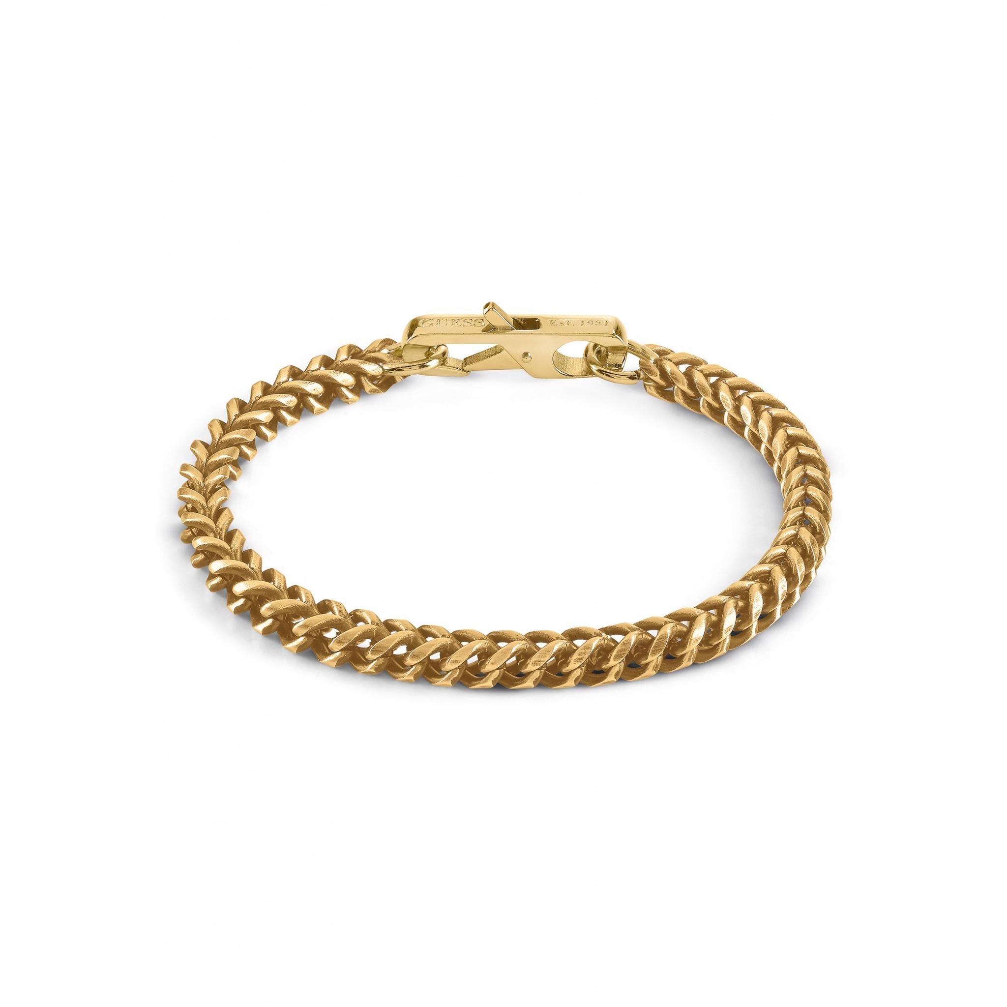 The GUESS JEWELLERY UMB01338YGL Gents mY Gold Tone Stainless Steel Curb Bracelet features a gold tone flat curb link design with a rectangular clasp, showcased on a white background.