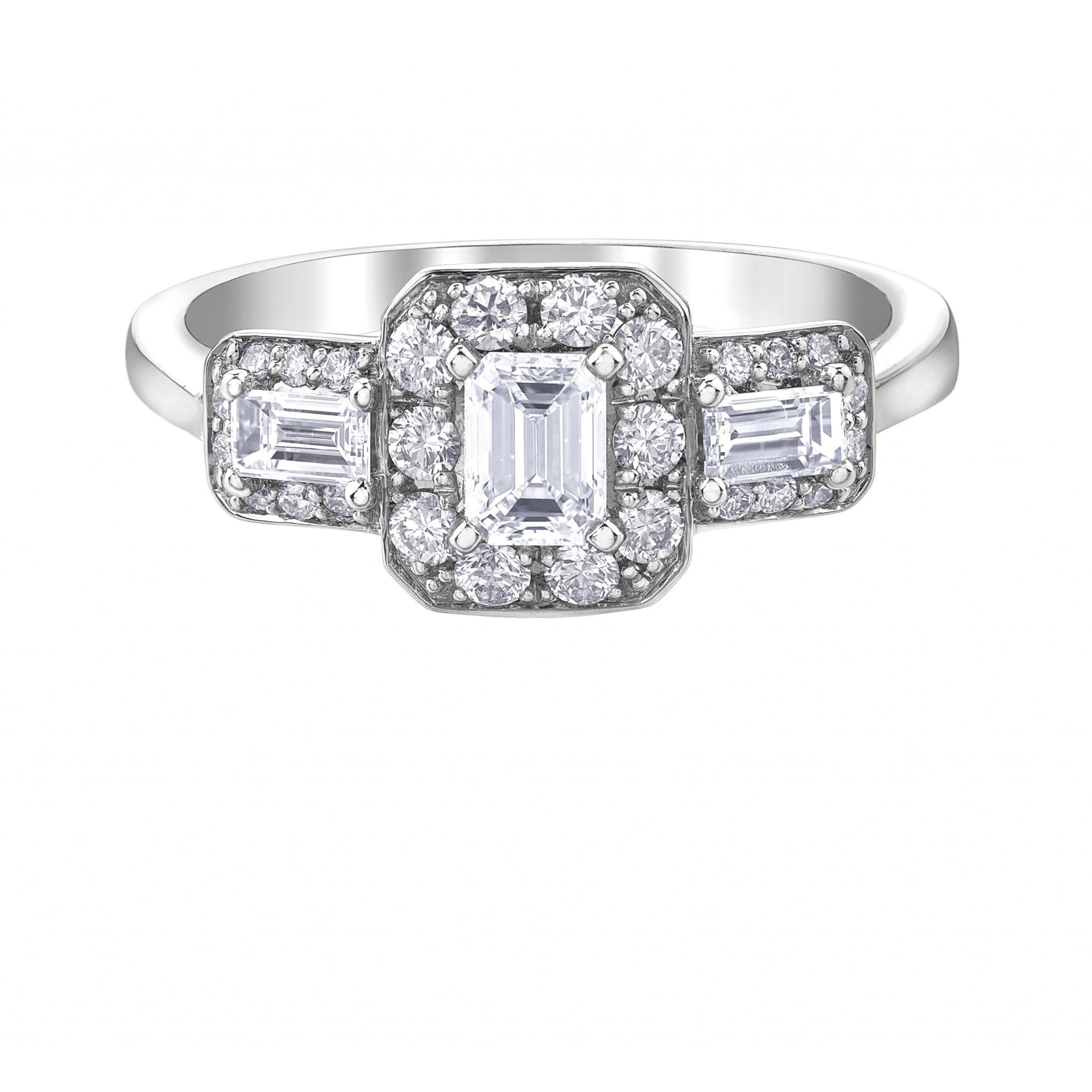 The 9ct White Gold Emerald Cut Diamond Trilogy Ring 0.85ct showcases a central emerald-cut diamond with a sparkling halo and two rectangular diamonds, each bordered by smaller stones for extra brilliance.