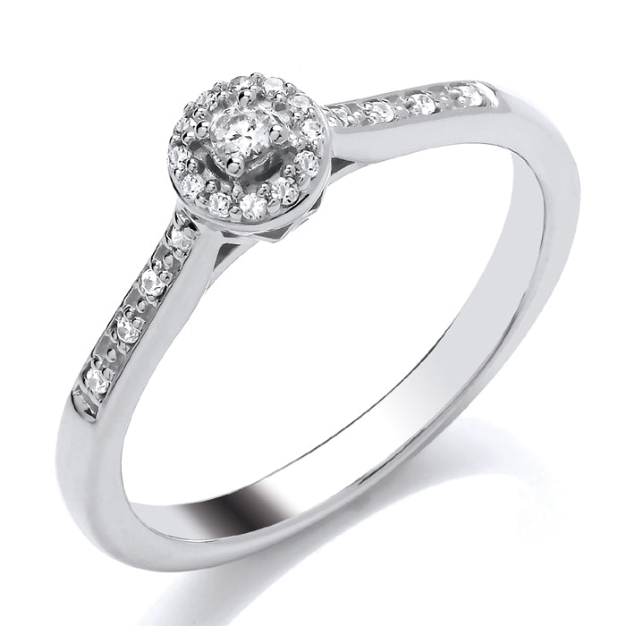 The 9ct White Gold Halo Diamond Cluster 0.10ct ring showcases a central diamond surrounded by a glittering halo of smaller diamonds, with extra diamonds set along the elegant white gold band.
