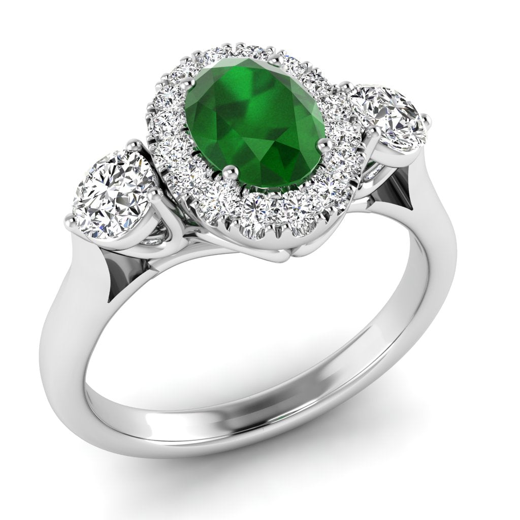 The 9ct White Gold Emerald and Diamond Trilogy Ring 0.45ct showcases a vibrant oval emerald flanked by two sparkling diamonds—a beautiful and timeless choice for an engagement ring.