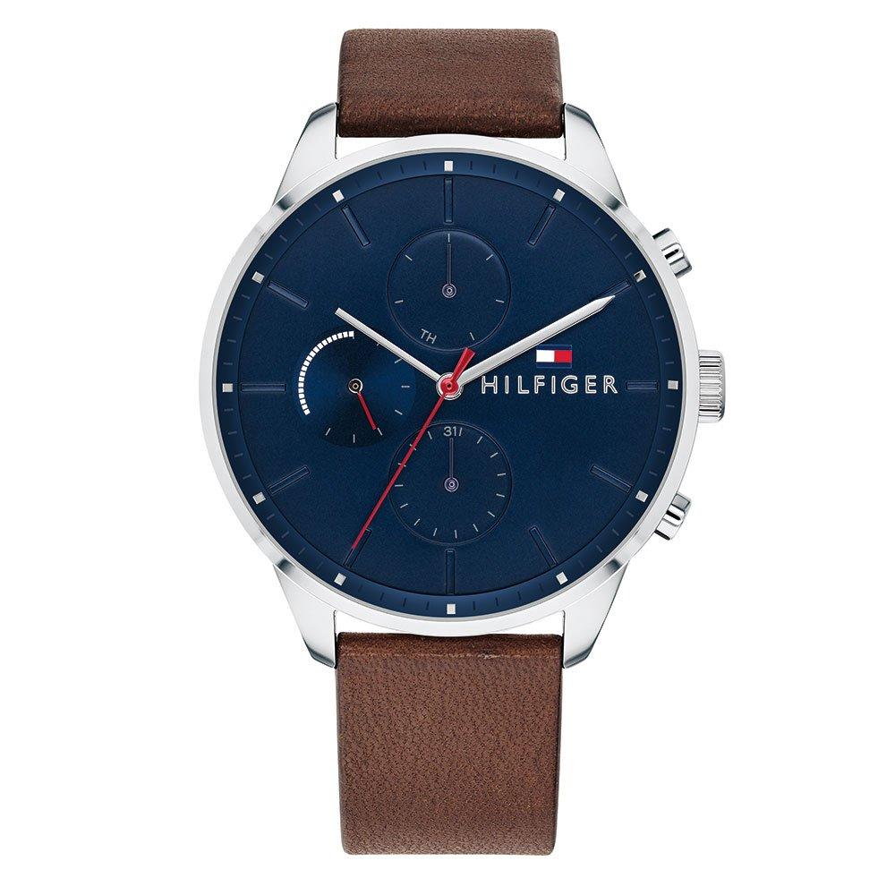 The Tommy Hilfiger 1791487 Chase watch features a blue dial, silver case, brown leather strap, three subdials, silver hour markers, and signature Hilfiger branding.