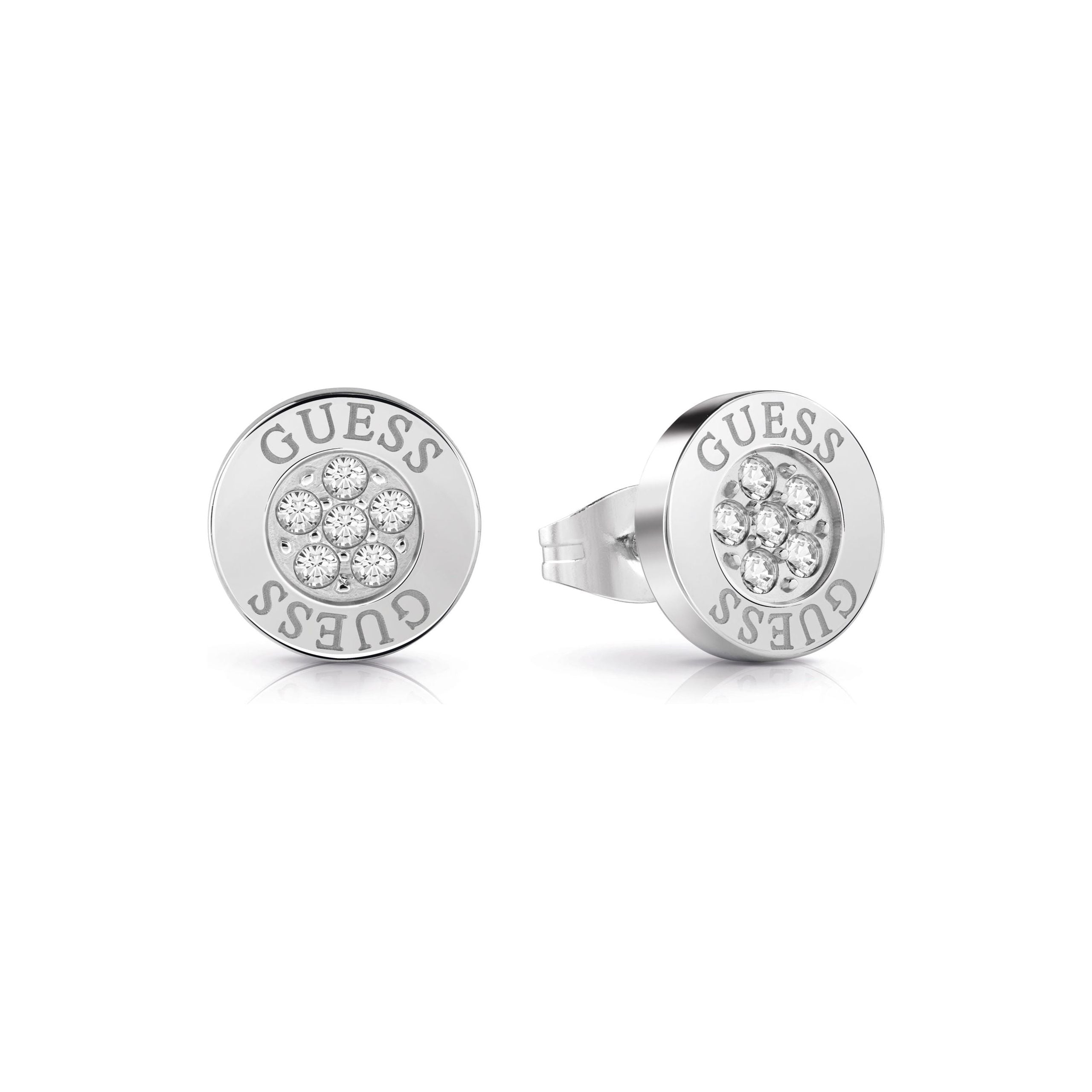 The Guess Love Knot Silver Tone Crystal Round Stud Earrings (UBE78022) feature a central cluster of crystals and "GUESS" engraved on the edge, inspired by the brand’s iconic Love Knot design.