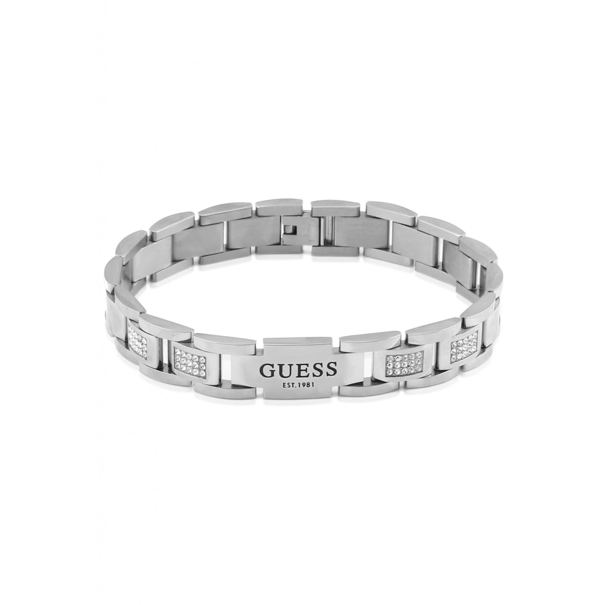 The GUESS JEWELLERY UMB01342ST Gents Frontiers Bracelet features a silver-tone stainless steel design with rectangular stone-set segments and a central plate engraved with "GUESS EST. 1981," reflecting the brand's signature style.