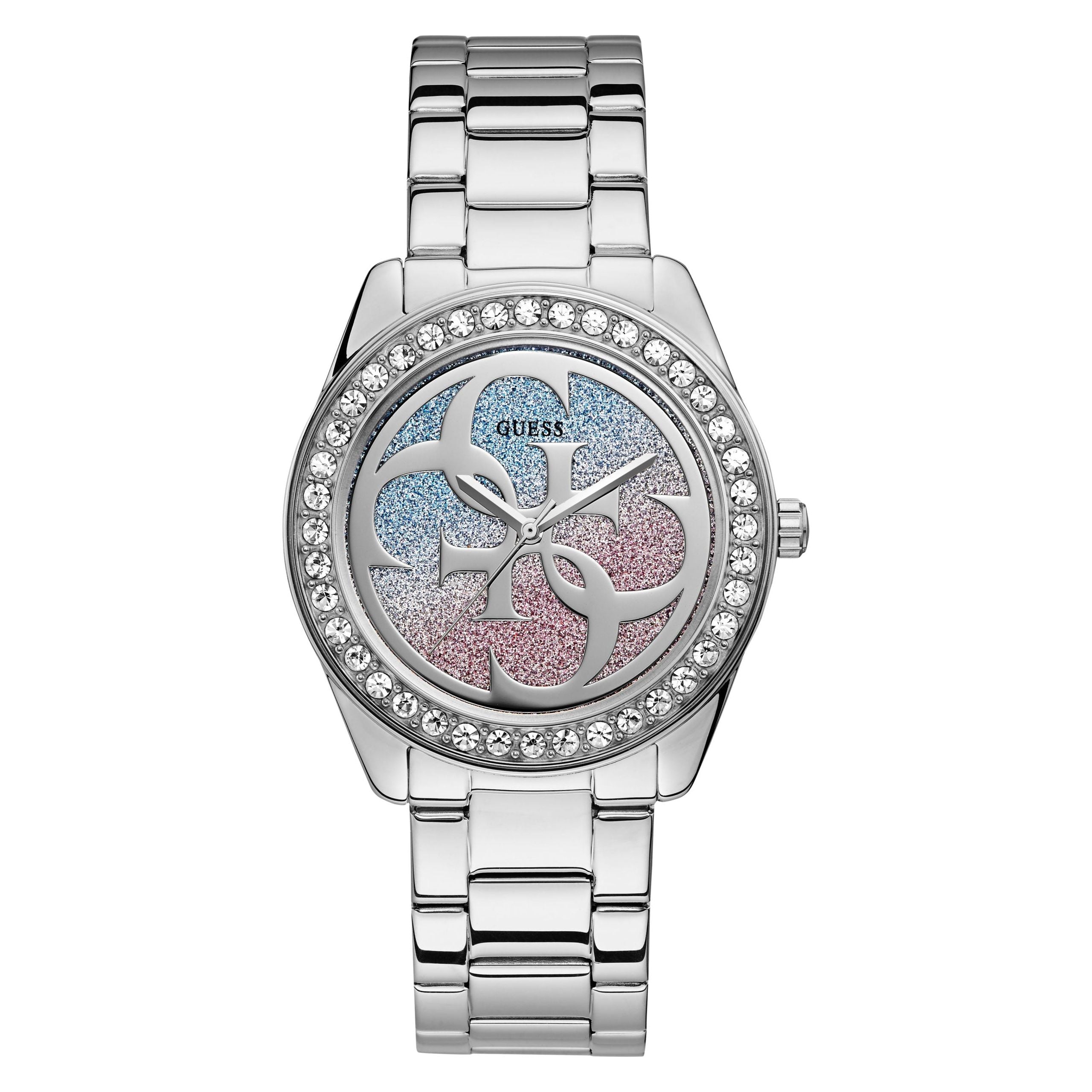 Guess Ladies G Twist Silver Tone Watch W1201L1 with a round face, Swarovski crystal-studded bezel, silver bracelet, and a dial featuring pink and blue glitter accents plus decorative overlapping "G" motifs.