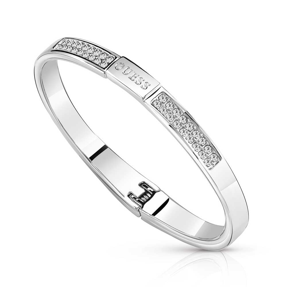 The Guess Colors Crystal Clear Silver Bangle UBB84084-S features clear crystals set in rectangular sections and a hinged clasp—an elegant accessory for any occasion.