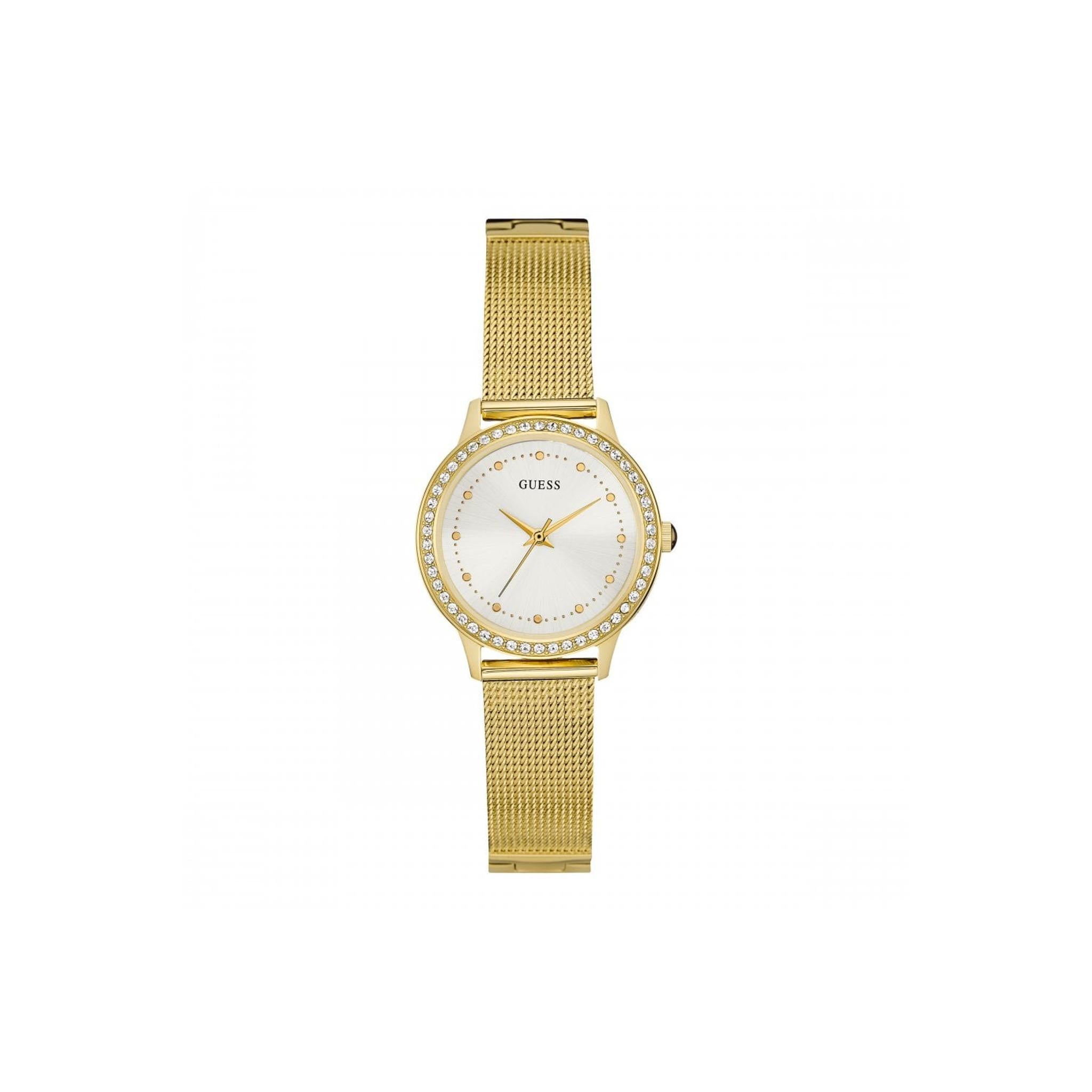 The Guess Ladies Chelsea Gold Plated Mesh Bracelet Watch W0647L7 features a round white dial, gold hands, crystal bezel accents, and a stylish gold mesh strap, shown against a plain white background.