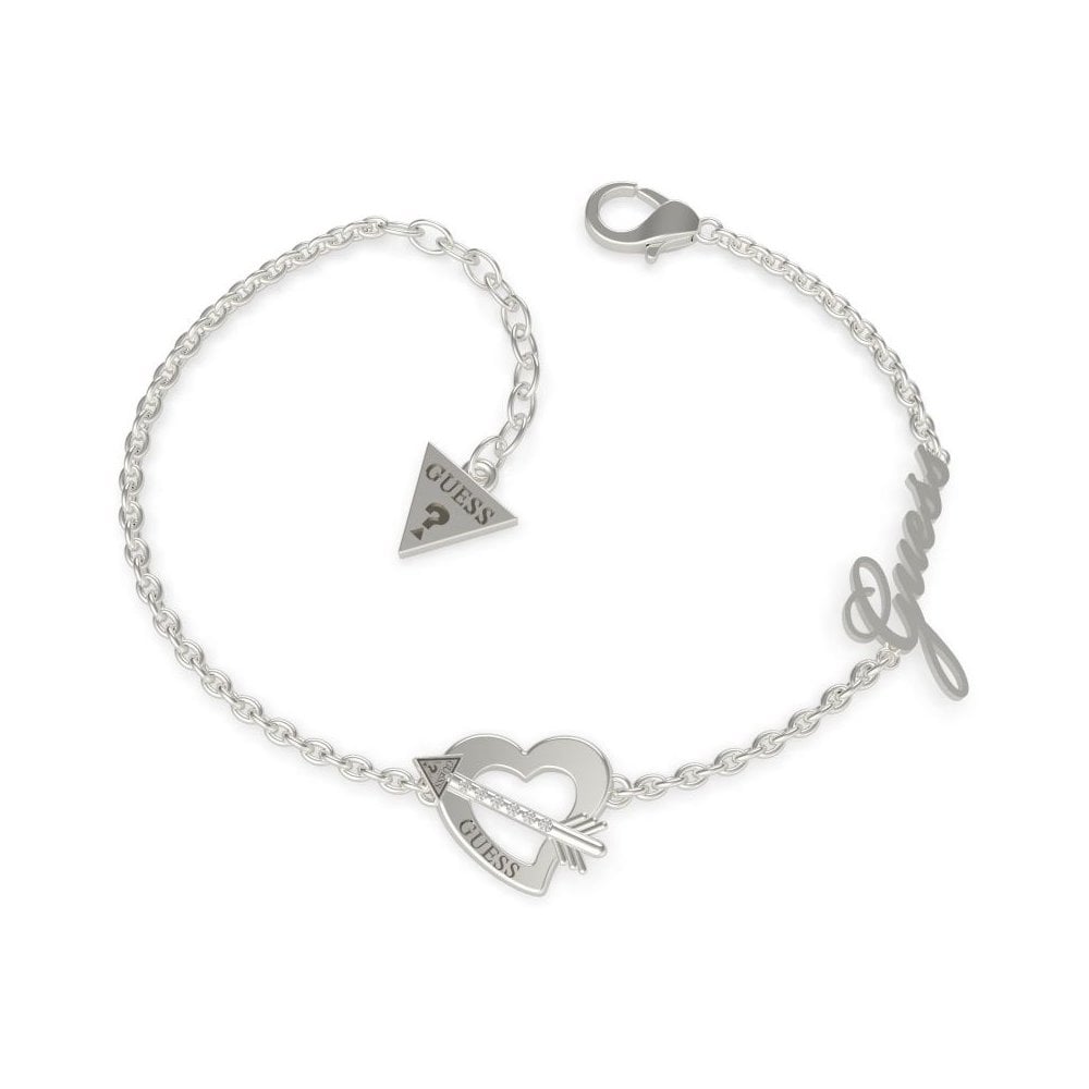 The GUESS Jewellery Across My Heart Rhodium plated Bracelet UBB79090-L features a heart with arrow, triangular Guess logo charm, and "Guess" script—an elegant piece from the dazzling Across My Heart collection.
