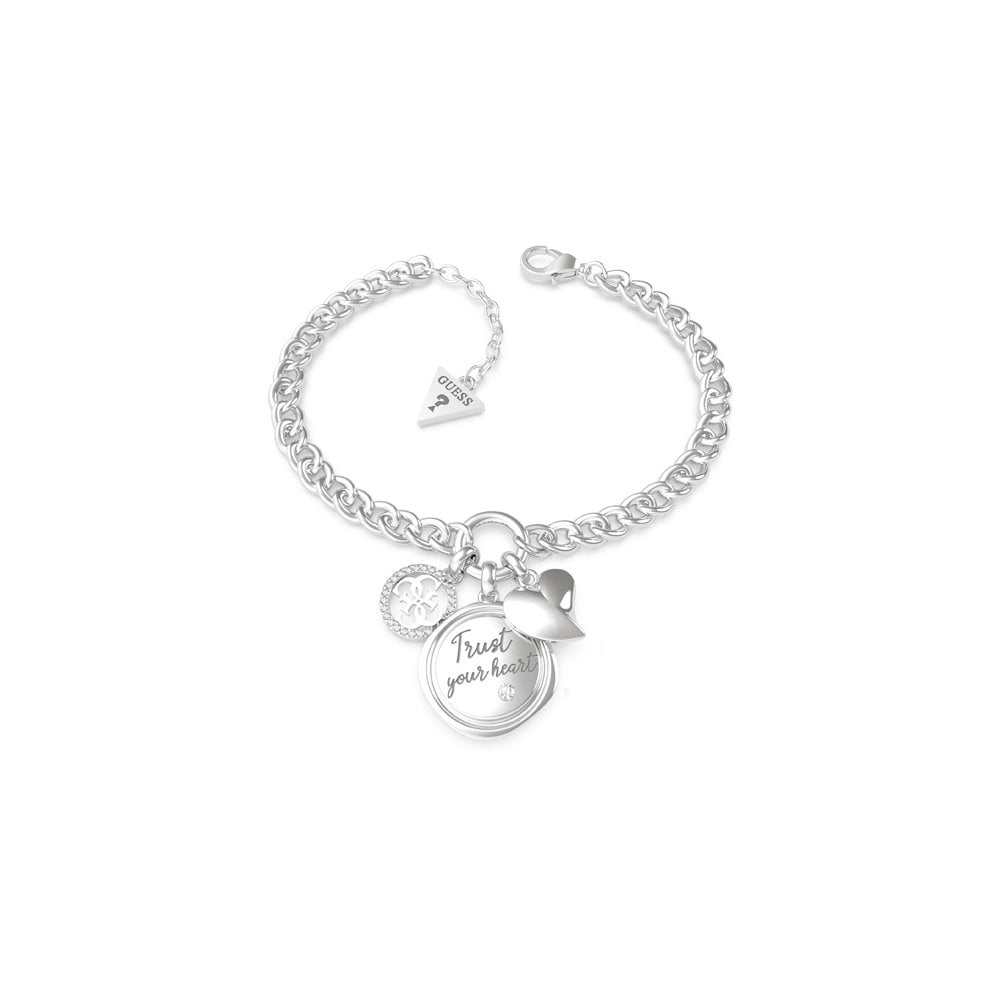 The Guess My Feelings Silver Tone Three Charm Bracelet UBB70047-L features a round "Trust your heart" charm, a heart, and the GUESS 4G logo. Perfect for stacking or wearing solo.