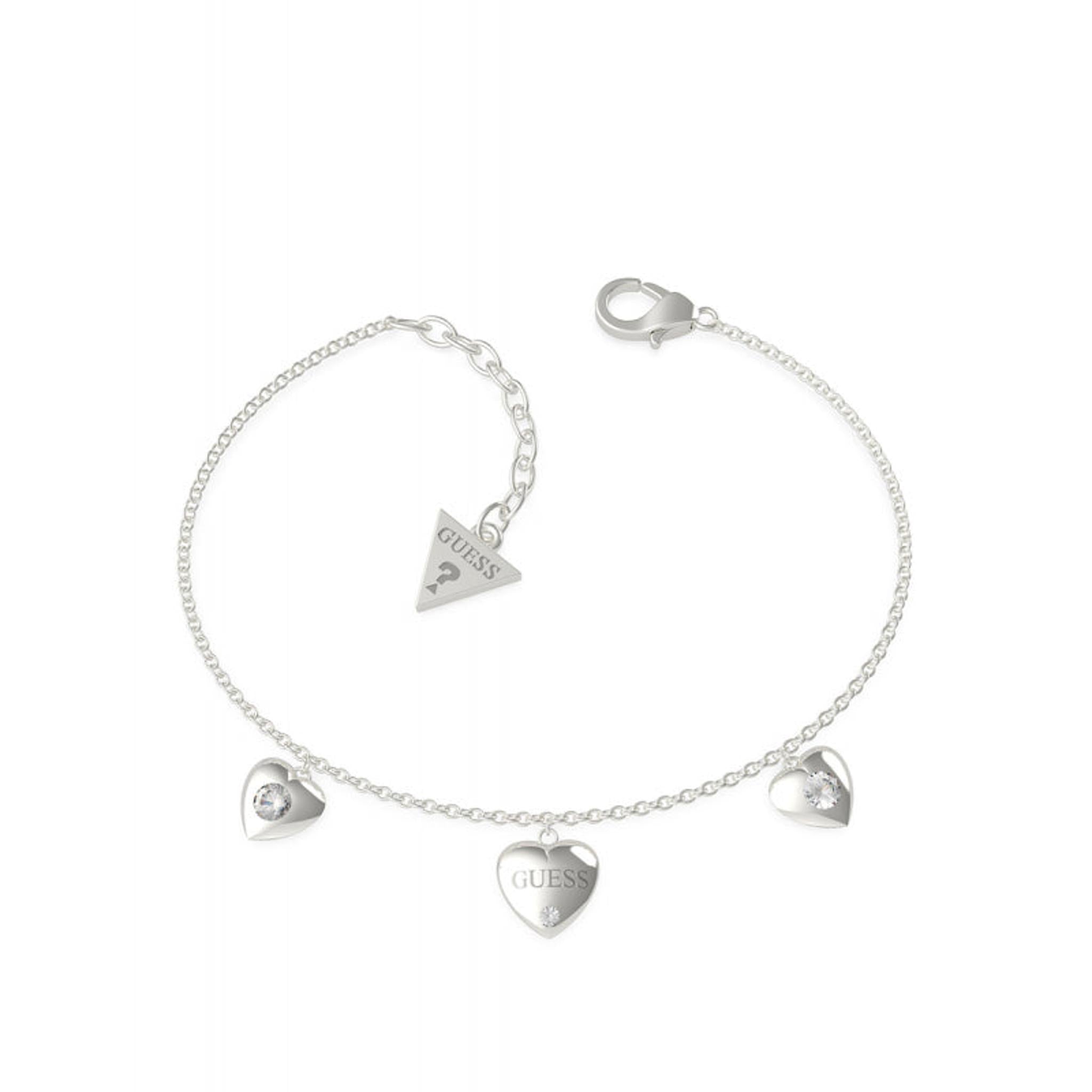 The GUESS Jewellery UBB70037-L "Is For Lovers" bracelet features three silver-tone heart charms, one engraved with "GUESS," plus a triangle tag by the clasp. Part of the stylish GUESS Jewellery collection.