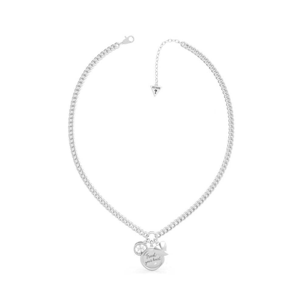 The Guess My Feelings Silver Tone Three Charm Necklace UBB70038 features a round "Trust your heart" pendant, a sparkling crystal, and a cut-out heart disc.