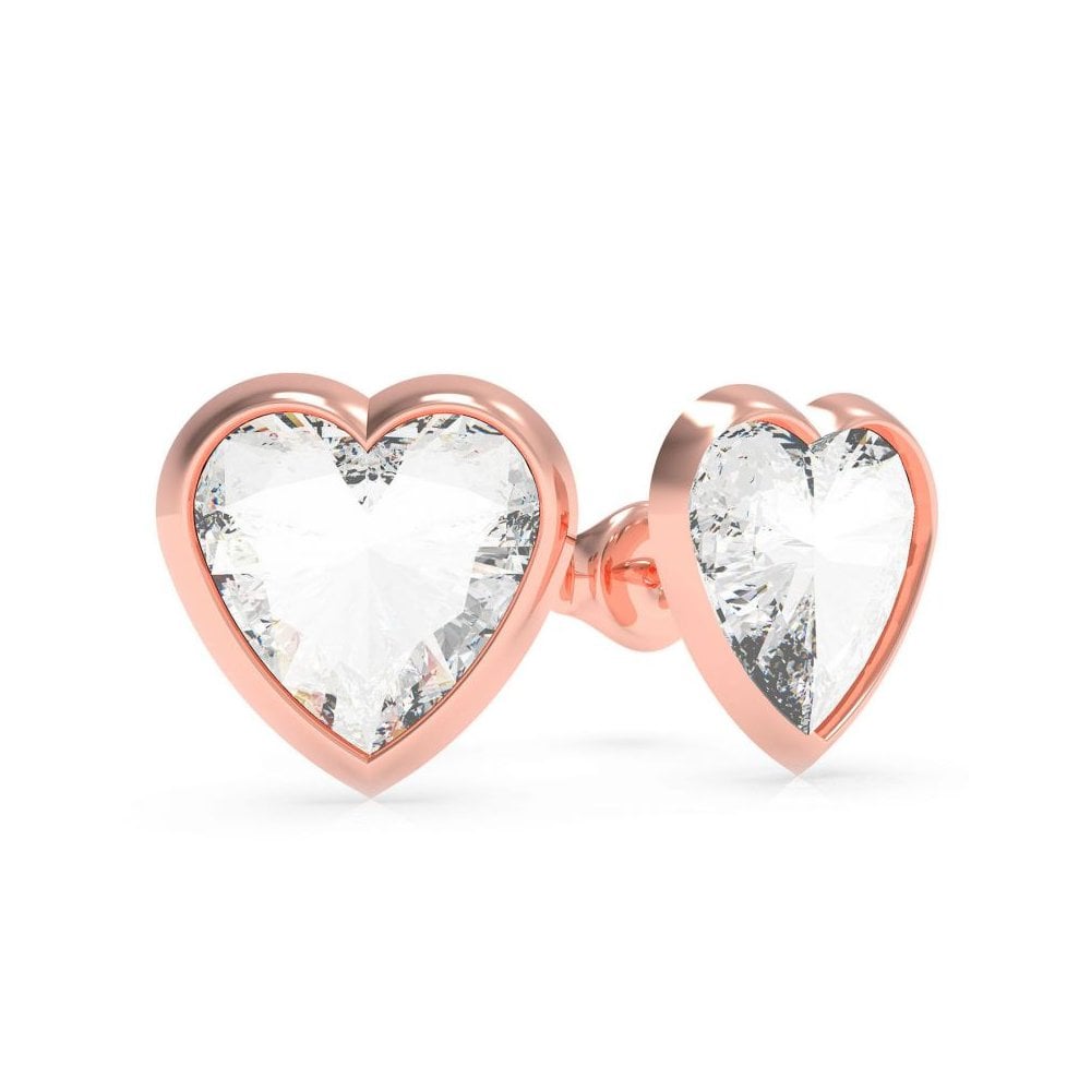 The GUESS JEWELLERY With Love Rose Gold Tone Crystal Earrings UBE70041 feature heart-shaped studs adorned with clear crystals, adding a sparkling touch to any outfit.