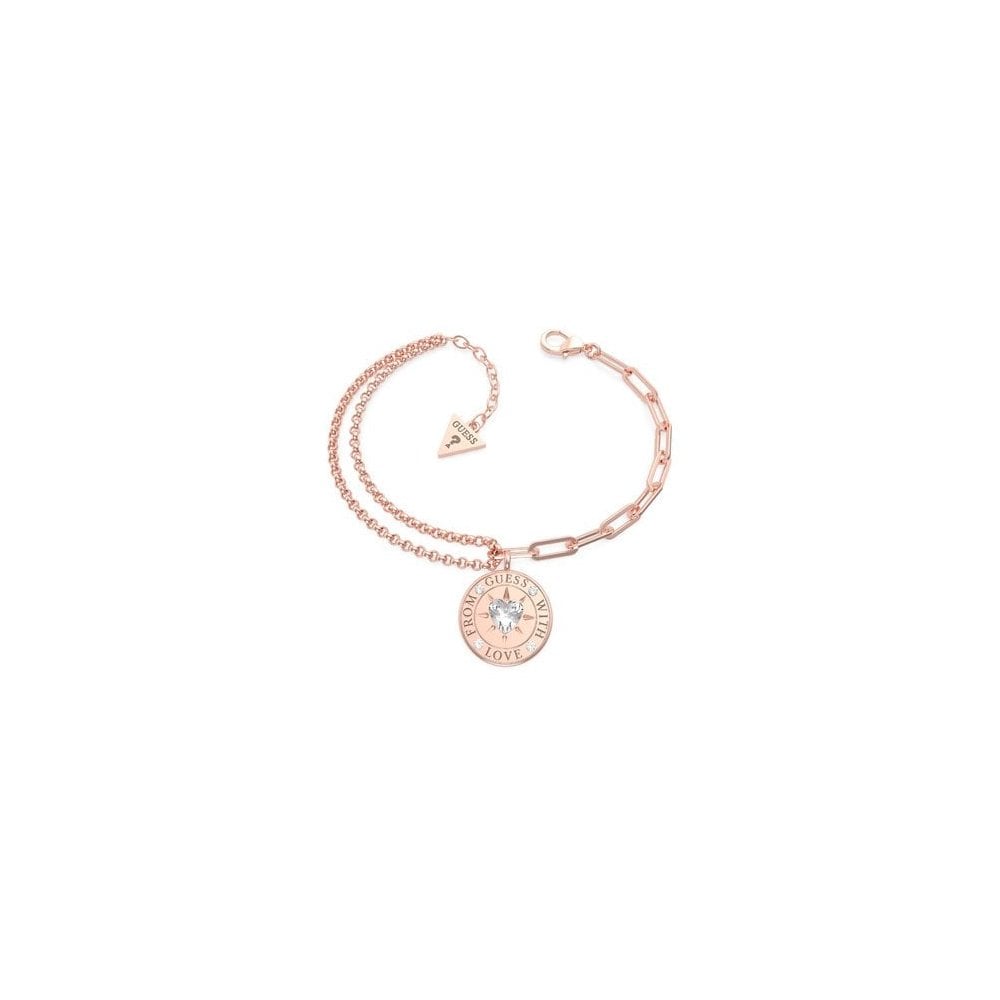 The GUESS JEWELLERY Ladies With Love Rose Gold Tone Double Chain Bracelet (UBB70002-L) features a circular "Love" charm, heart-shaped crystal accent, and small triangular tag, shown on a white background.