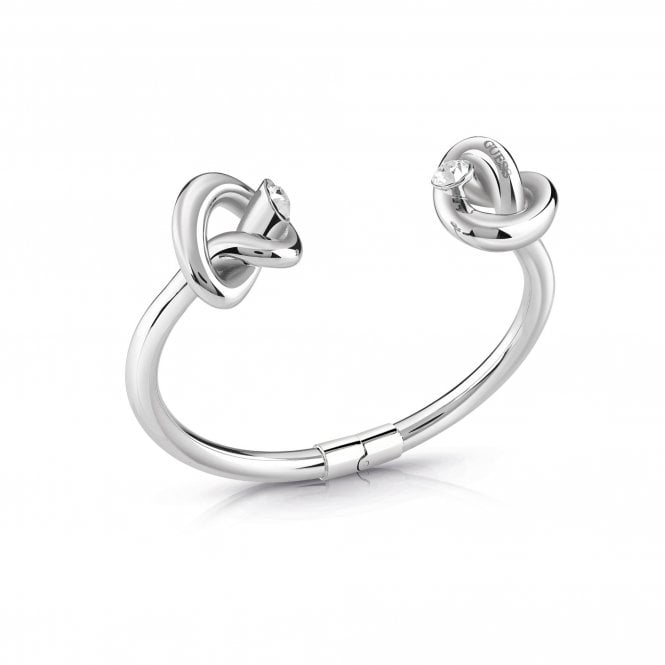 The Guess Jewellery Double Knot Bangle Silver Tone Bracelet UBB29015-L features two knot designs with small round Swarovski crystals, displayed on a white background.