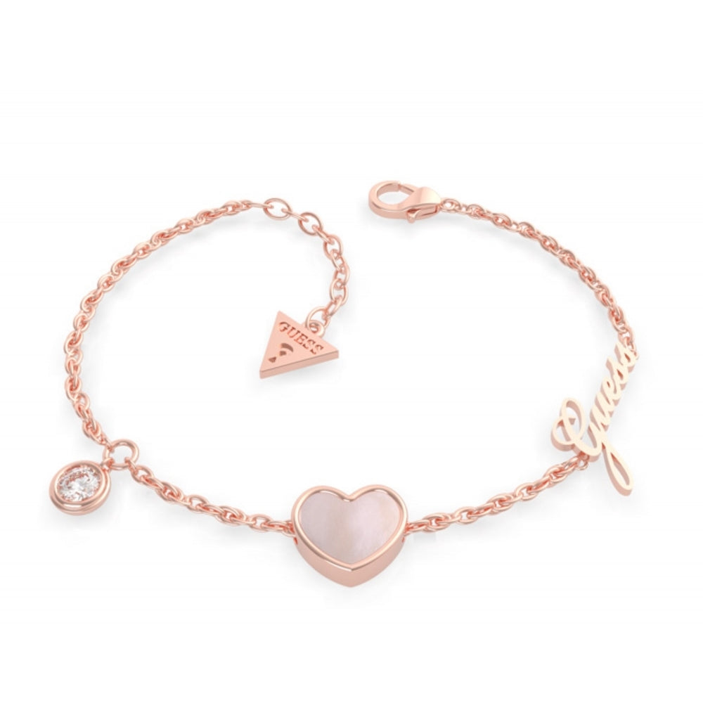 The GUESS Sea Gift Rose-Gold Mother Of Pearl Heart Crystal Bracelet UBB79023-L features a heart charm, round crystal, "Guess" script charm, and triangle tag from the Sea Gift collection.