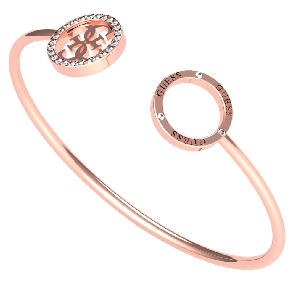 The Guess UBB79081-L Women's Rose Gold Plated Tone Equilibre Logo Bangle features two round ends—one with crystals and a cut-out logo, the other engraved repeatedly with "GUESS" for a signature look.