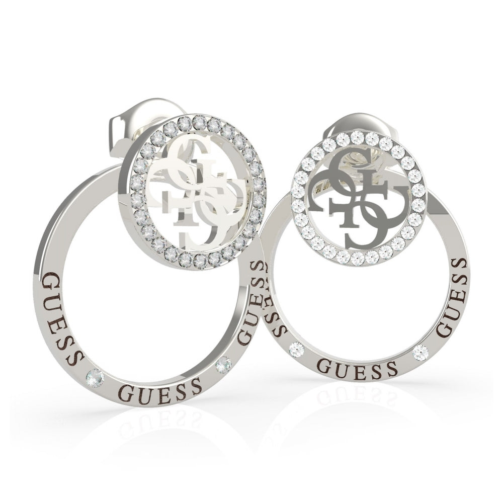 The Guess UBE79095 Women's Silver Tone Equilibre Stud Earrings feature circular designs with sparkling Swarovski crystals and the Guess logo accenting the stainless steel edges.