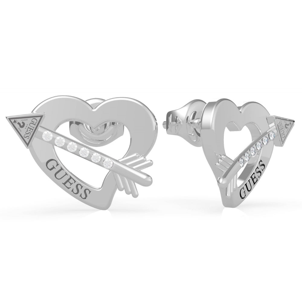 The Guess UBE79121 Women's Rhodium Plated Across My Heart Stud Earrings feature heart and arrow designs with sparkling Swarovski crystals and "GUESS" engraved on each heart.
