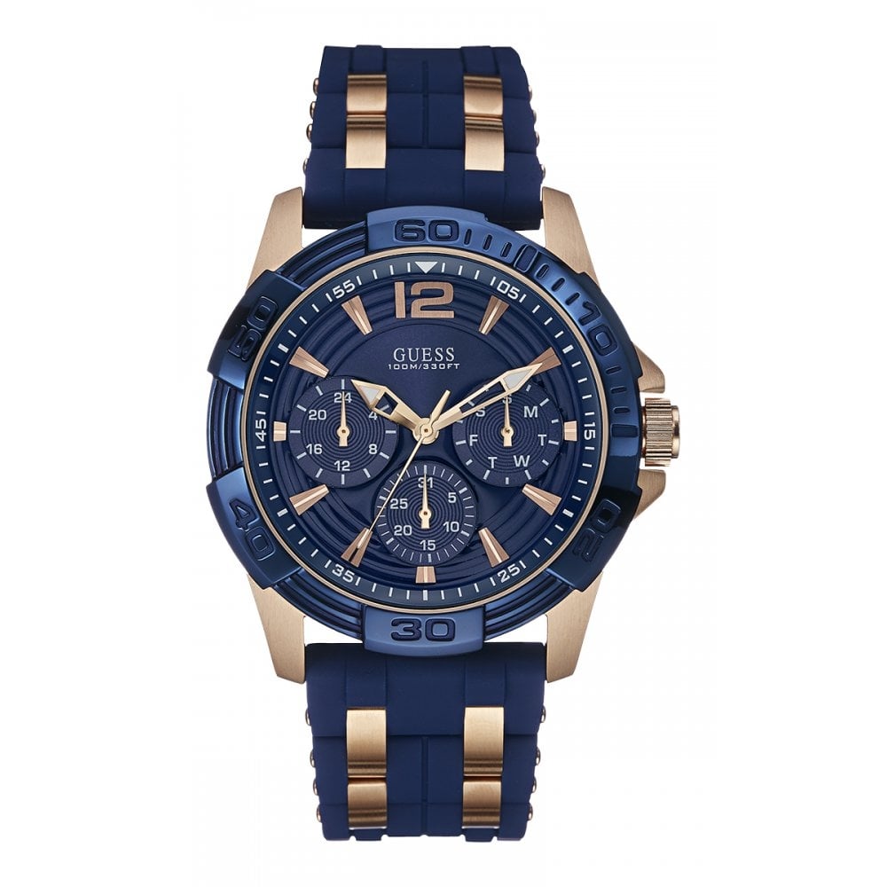 The Guess W0366G4 Men's Oasis Wristwatch features a blue dial with rose gold-tone accents, three subdials, date display, and a blue silicone strap.