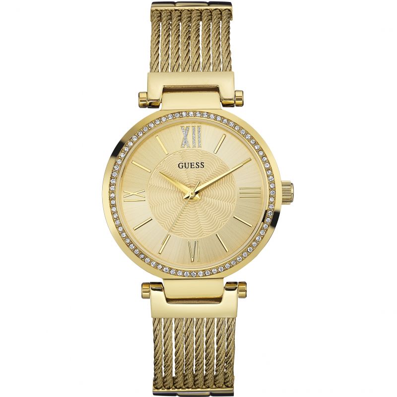 The GUESS Ladies Soho Gold Tone watch (W0638L2) features a gold tone dial, crystal-set bezel, Roman numeral markers, and a stylish wire cable style bracelet.