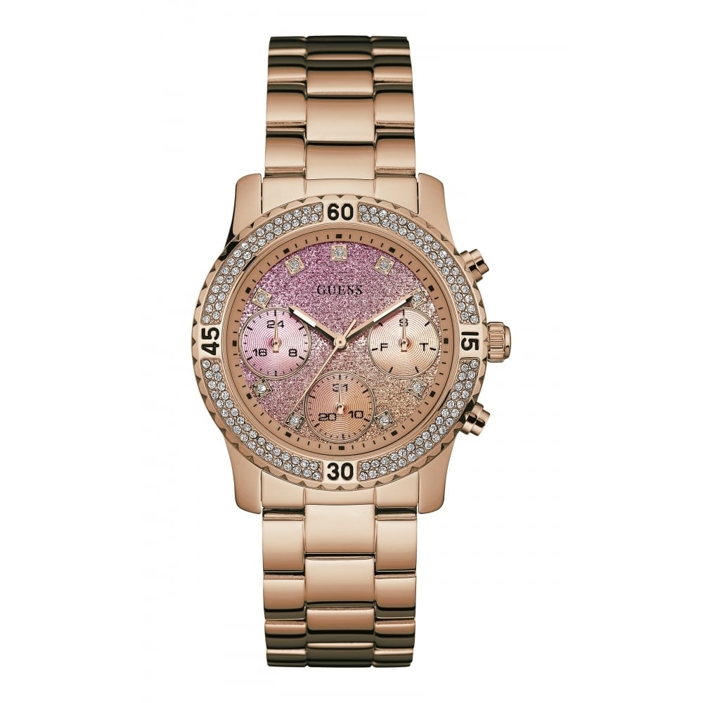 The Guess W0774L3 Women's Confetti Watch features a rose gold link bracelet, crystal bezel, pink dial with three subdials, and silver hour markers.