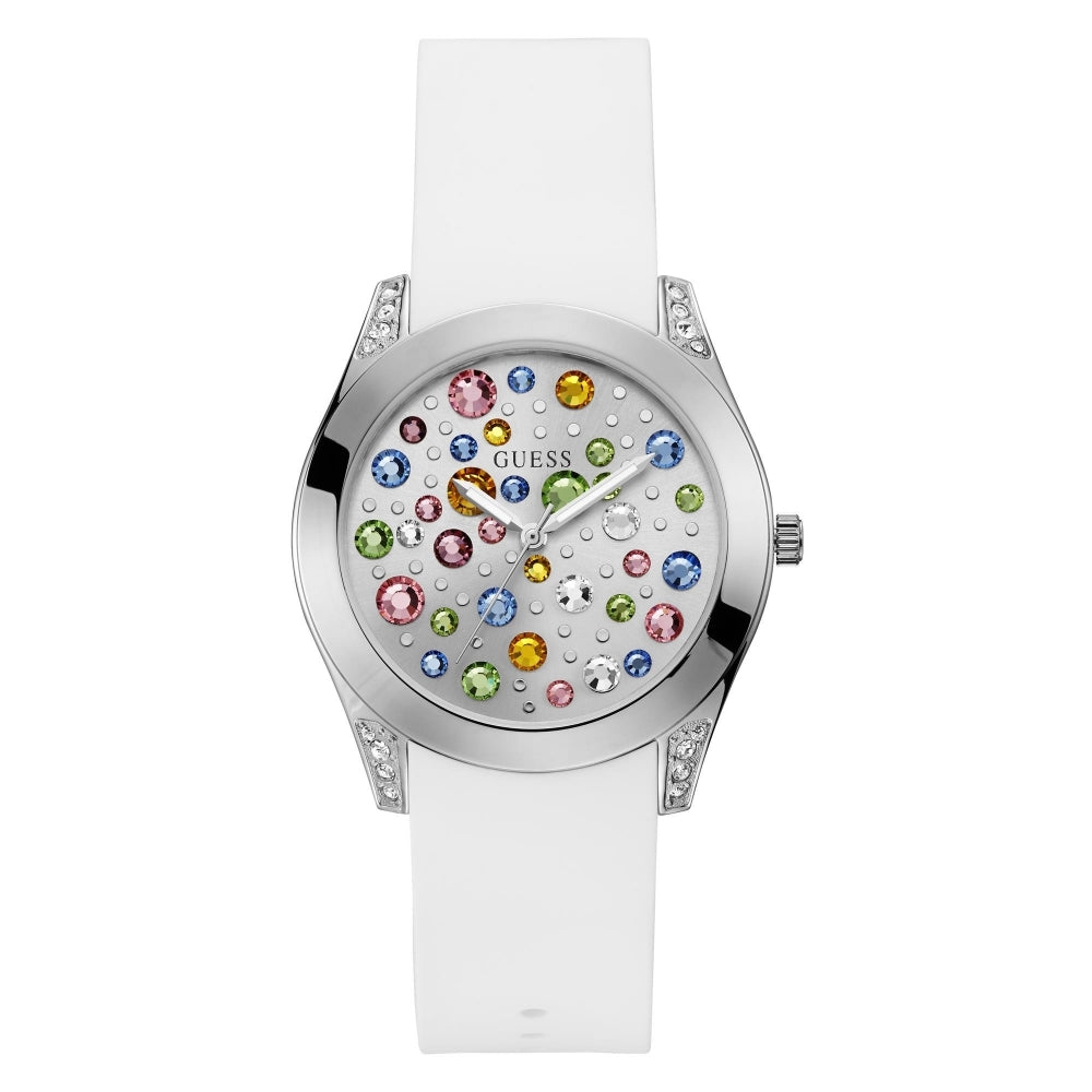 The Guess Ladies Wonderlust Watch W1059L1 features a silver case, a white silicone strap, and a dial embellished with multicolored gemstones in different sizes for a chic, modern style.